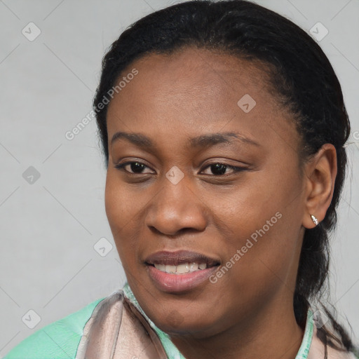 Joyful black young-adult female with short  black hair and brown eyes