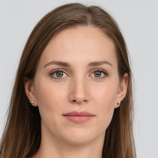 Joyful white young-adult female with long  brown hair and grey eyes