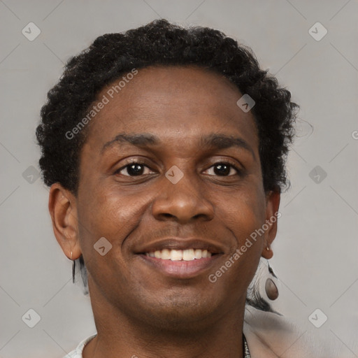 Joyful black young-adult male with short  brown hair and brown eyes