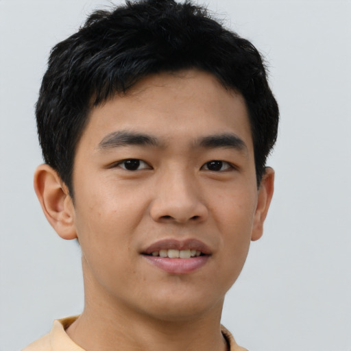 Joyful asian young-adult male with short  brown hair and brown eyes