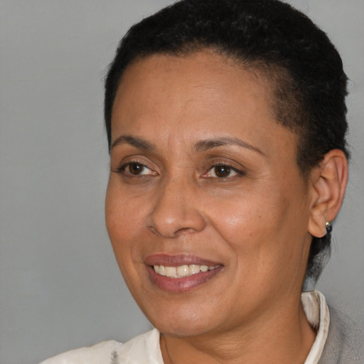 Joyful latino adult female with short  brown hair and brown eyes