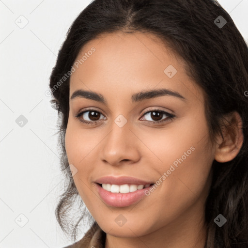 Joyful latino young-adult female with long  brown hair and brown eyes