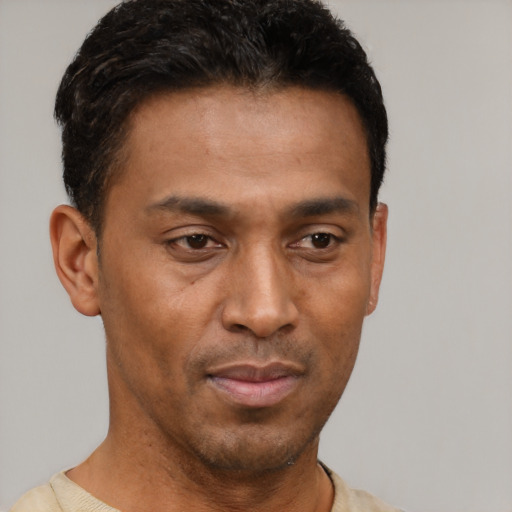 Neutral latino young-adult male with short  brown hair and brown eyes