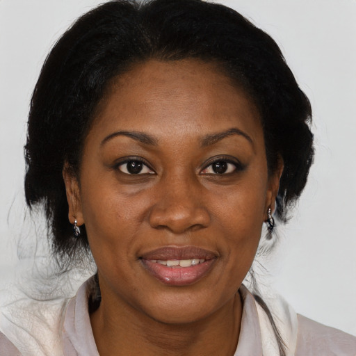 Joyful black adult female with medium  brown hair and brown eyes