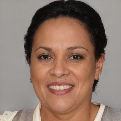 Joyful latino adult female with short  brown hair and brown eyes