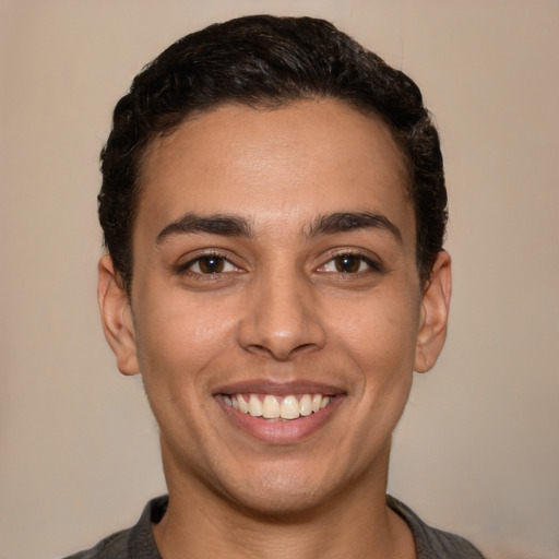 Joyful latino young-adult male with short  brown hair and brown eyes