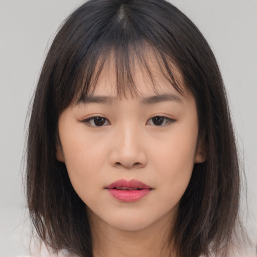 Neutral asian young-adult female with medium  brown hair and brown eyes