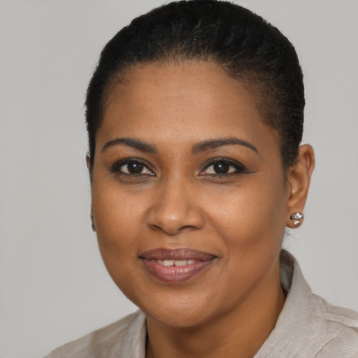 Joyful black young-adult female with short  brown hair and brown eyes