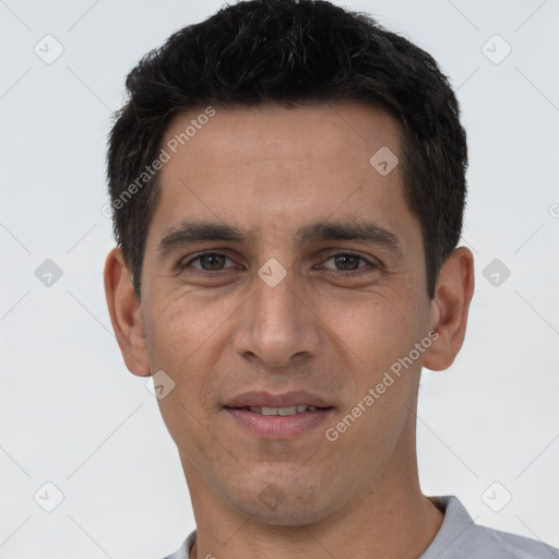 Joyful white young-adult male with short  black hair and brown eyes