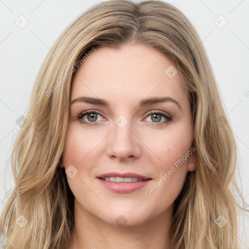 Joyful white young-adult female with long  brown hair and green eyes