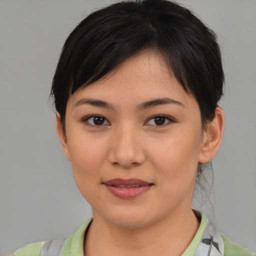 Joyful asian young-adult female with medium  brown hair and brown eyes