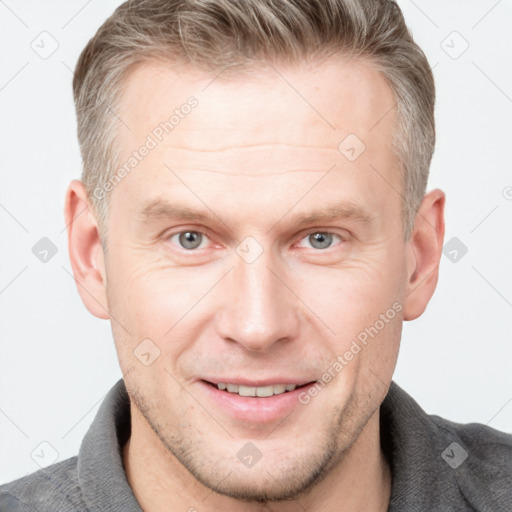 Joyful white adult male with short  brown hair and grey eyes