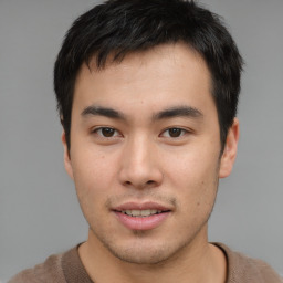 Joyful asian young-adult male with short  brown hair and brown eyes