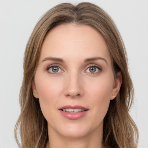 Joyful white young-adult female with long  brown hair and green eyes