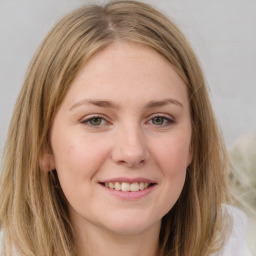 Joyful white young-adult female with long  brown hair and green eyes