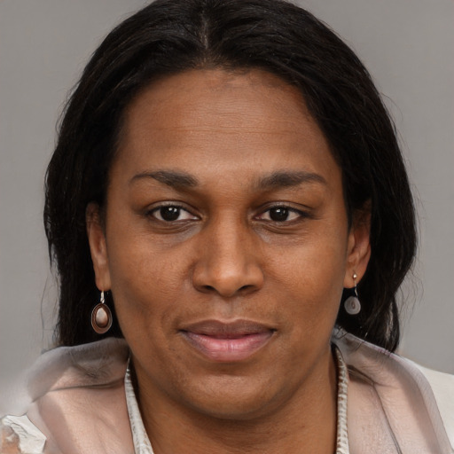 Joyful black adult female with medium  brown hair and brown eyes