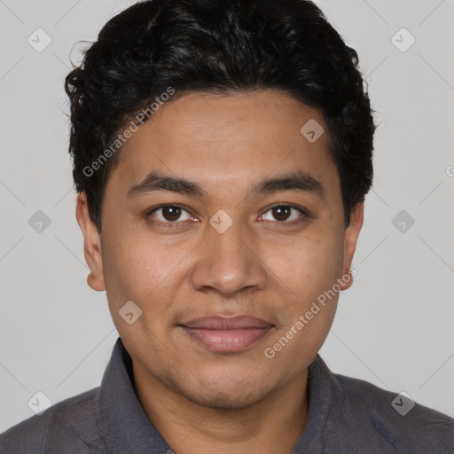 Joyful latino young-adult male with short  black hair and brown eyes