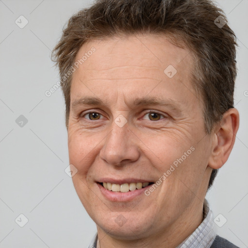 Joyful white adult male with short  brown hair and brown eyes