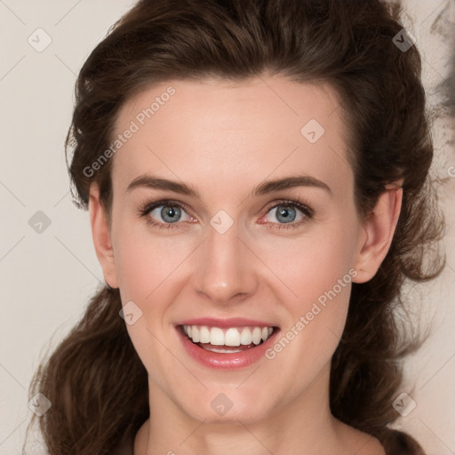 Joyful white young-adult female with medium  brown hair and green eyes