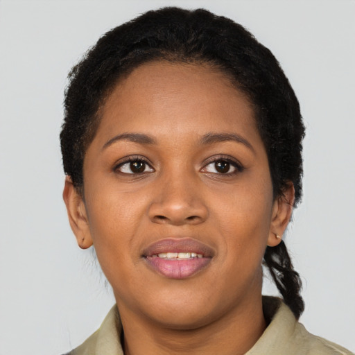 Joyful black young-adult female with short  black hair and brown eyes