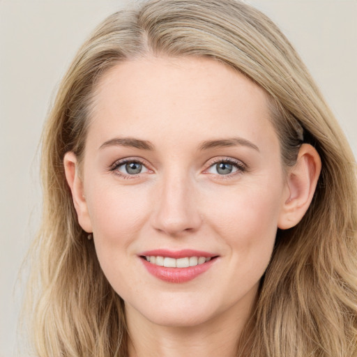 Joyful white young-adult female with long  brown hair and blue eyes