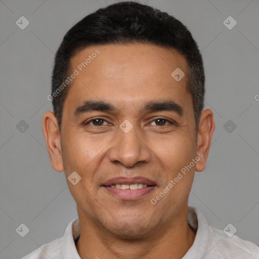 Joyful latino adult male with short  black hair and brown eyes