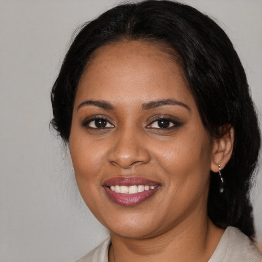 Joyful black young-adult female with medium  black hair and brown eyes