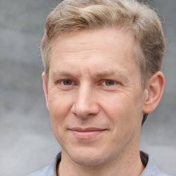 Joyful white adult male with short  brown hair and grey eyes