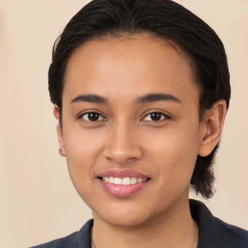 Joyful white young-adult female with short  black hair and brown eyes