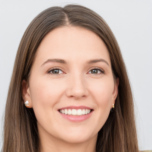 Joyful white young-adult female with long  brown hair and grey eyes