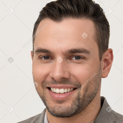 Joyful white young-adult male with short  brown hair and brown eyes