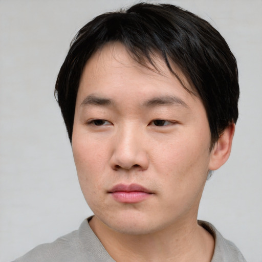 Neutral asian young-adult male with short  brown hair and brown eyes