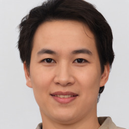 Joyful asian young-adult male with short  brown hair and brown eyes