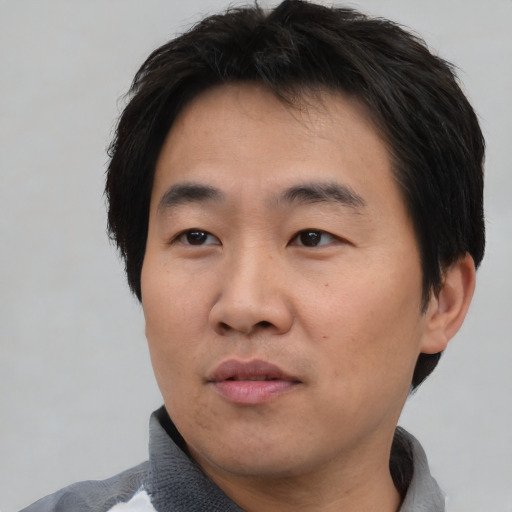 Neutral asian young-adult male with short  black hair and brown eyes