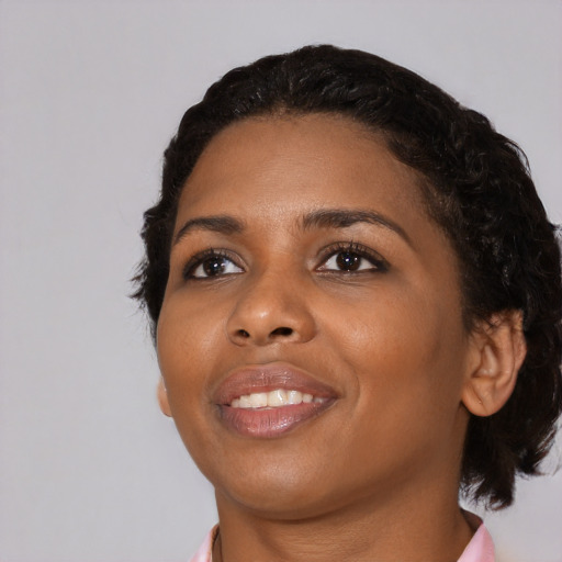 Joyful black young-adult female with medium  black hair and brown eyes