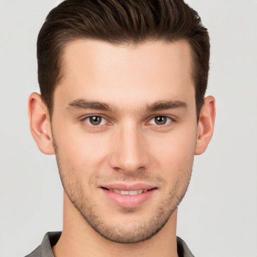 Joyful white young-adult male with short  brown hair and brown eyes