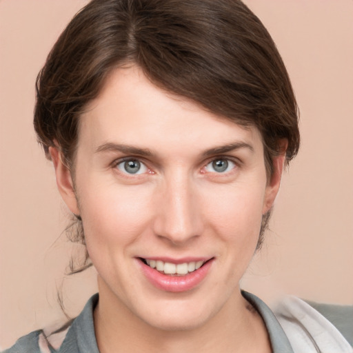 Joyful white young-adult female with short  brown hair and grey eyes