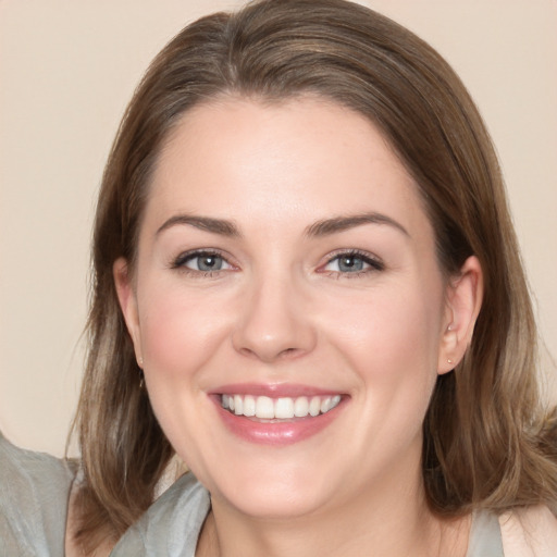 Joyful white young-adult female with medium  brown hair and grey eyes