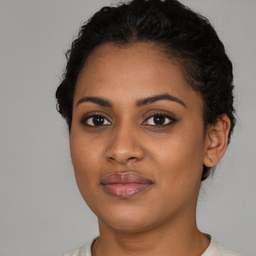 Joyful black young-adult female with short  brown hair and brown eyes