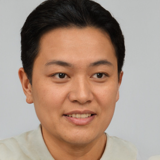 Joyful asian young-adult male with short  brown hair and brown eyes