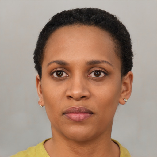Joyful latino young-adult female with short  black hair and brown eyes