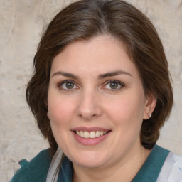 Joyful white young-adult female with medium  brown hair and green eyes