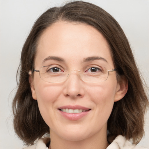 Joyful white adult female with medium  brown hair and grey eyes