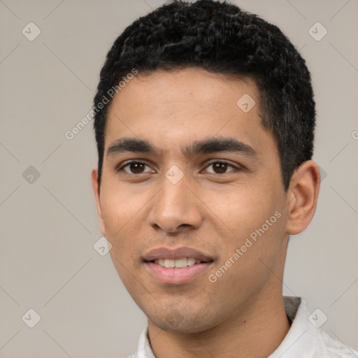 Joyful latino young-adult male with short  black hair and brown eyes