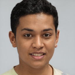 Joyful latino young-adult male with short  brown hair and brown eyes