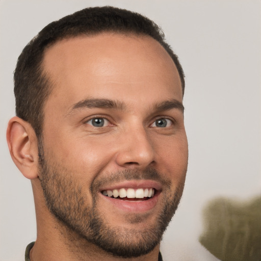 Joyful white young-adult male with short  brown hair and brown eyes