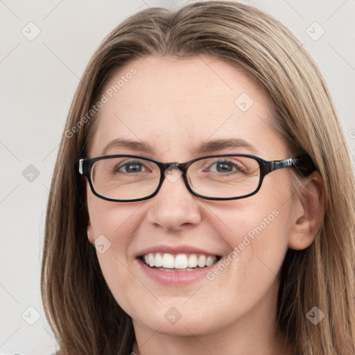 Joyful white young-adult female with long  brown hair and blue eyes