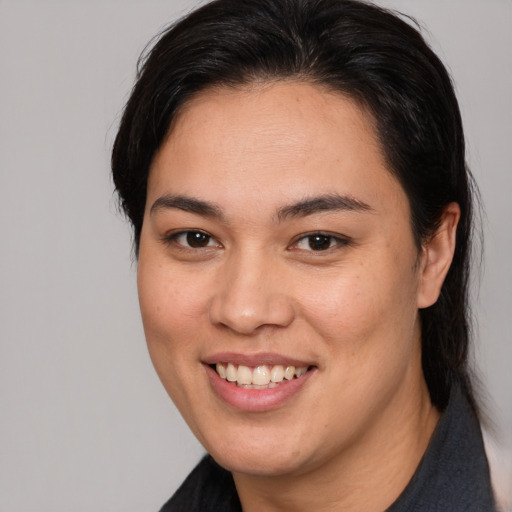 Joyful asian young-adult female with medium  brown hair and brown eyes