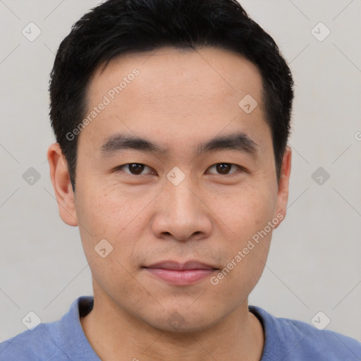 Joyful asian young-adult male with short  black hair and brown eyes