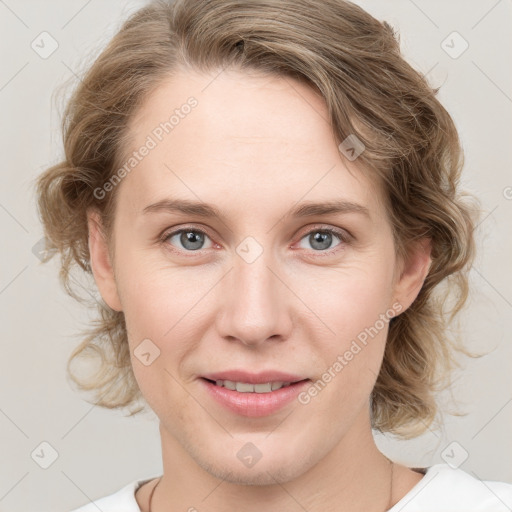 Joyful white young-adult female with medium  brown hair and blue eyes